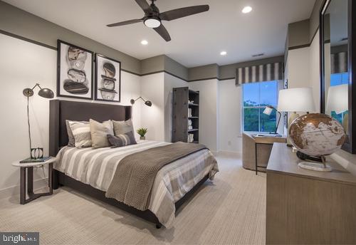 bedroom with ceiling fan and light colored carpet