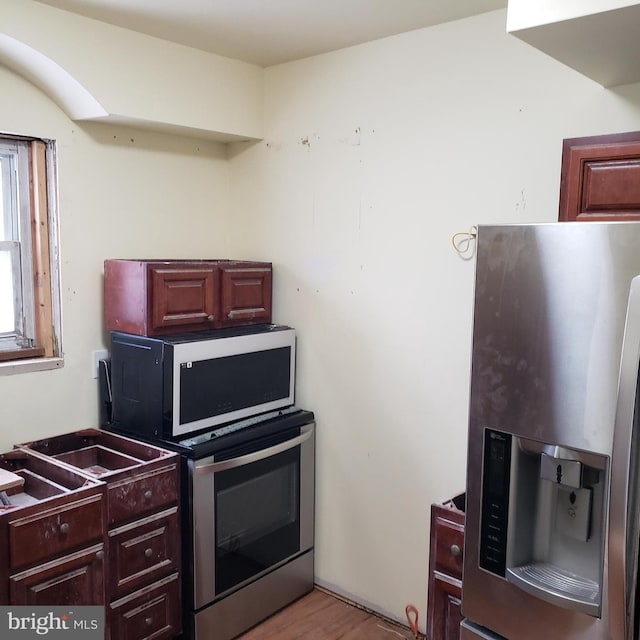 kitchen featuring stainless steel fridge with ice dispenser and light wood-type flooring