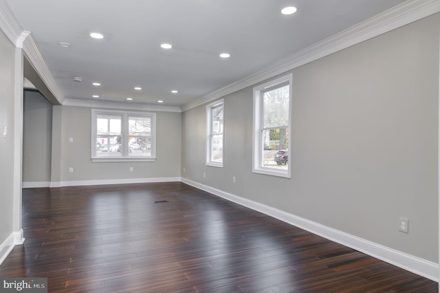 spare room featuring ornamental molding and dark hardwood / wood-style floors