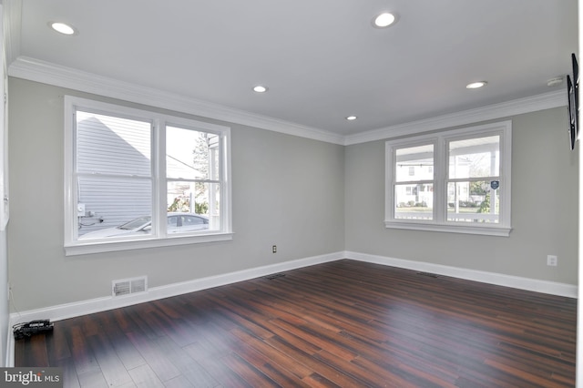 spare room with dark hardwood / wood-style floors and crown molding