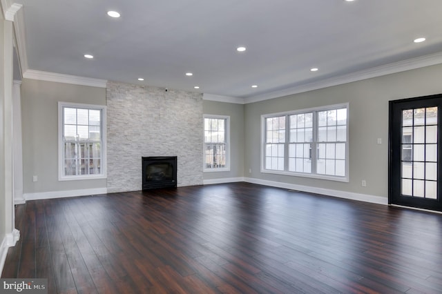 unfurnished living room featuring ornamental molding, a fireplace, and dark wood-type flooring