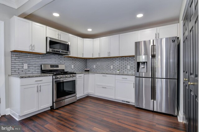 kitchen featuring stainless steel appliances, dark hardwood / wood-style floors, white cabinets, and light stone counters