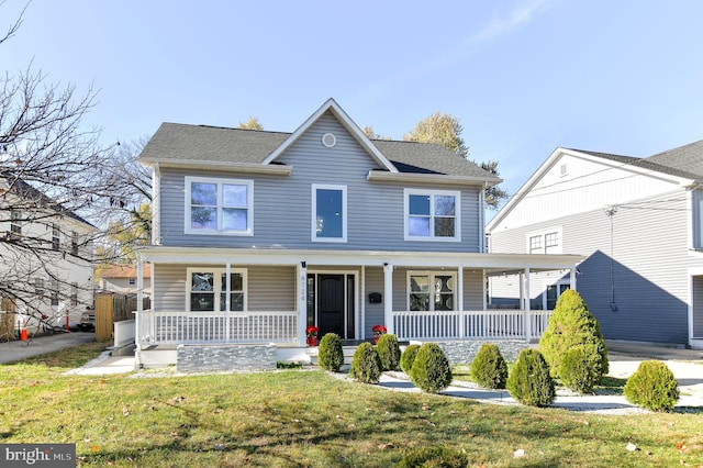 view of front of home featuring a front lawn and covered porch