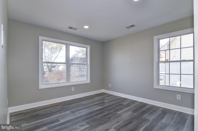 empty room with dark hardwood / wood-style flooring