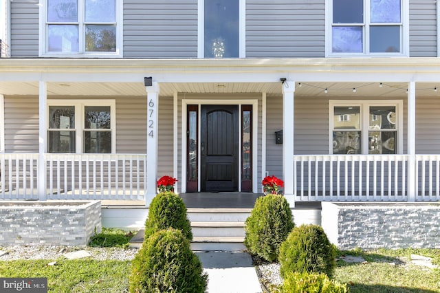 view of exterior entry with covered porch