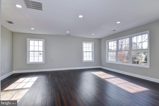 spare room featuring dark wood-type flooring