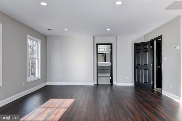 empty room with dark hardwood / wood-style flooring