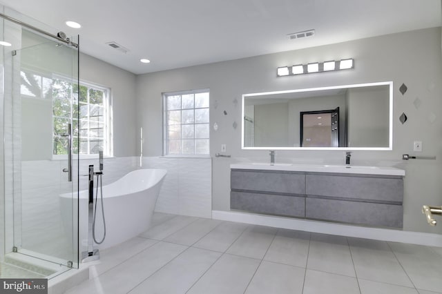 bathroom featuring separate shower and tub, tile walls, vanity, and tile patterned floors