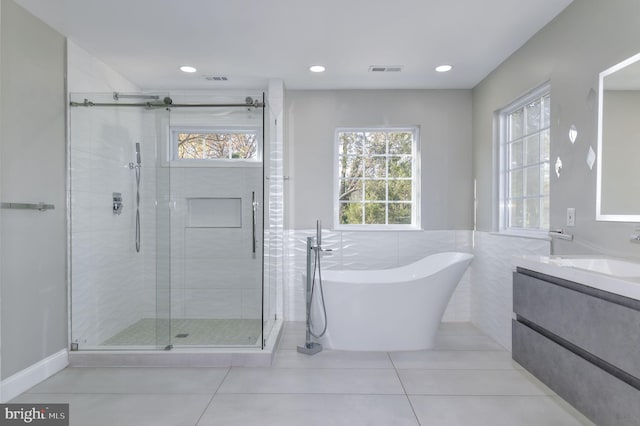 bathroom featuring vanity, tile patterned flooring, separate shower and tub, and tile walls