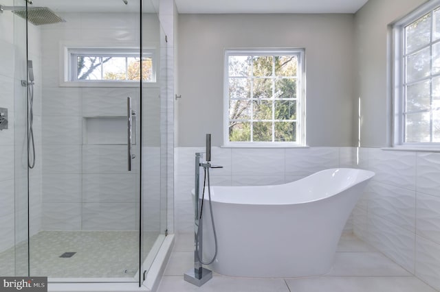 bathroom featuring tile walls, tile patterned floors, and independent shower and bath