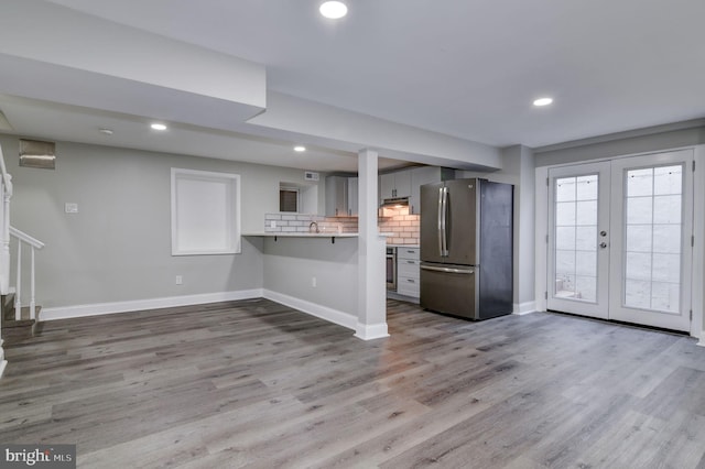 unfurnished living room with french doors and hardwood / wood-style flooring