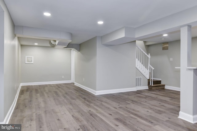 basement with light hardwood / wood-style floors