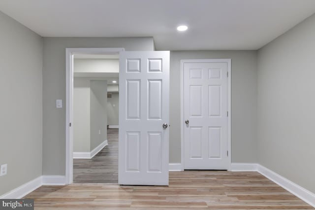 unfurnished bedroom with light hardwood / wood-style floors and a closet