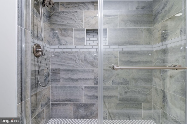 bathroom featuring a shower with door