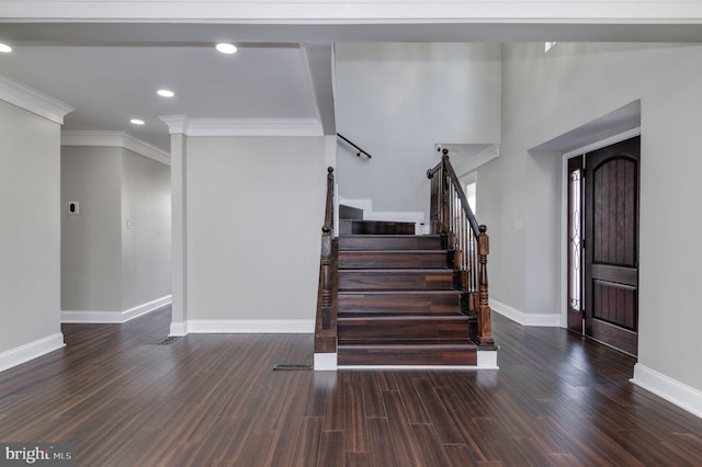 staircase featuring ornamental molding and hardwood / wood-style flooring