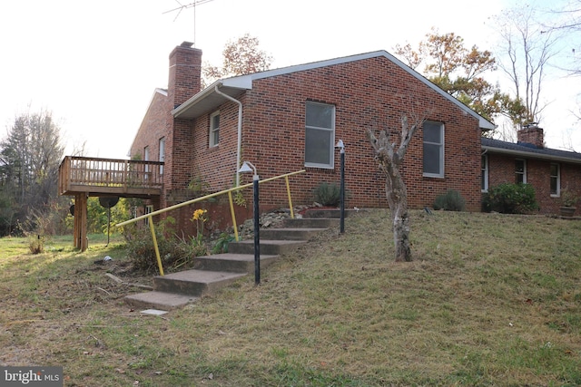 view of home's exterior with a lawn and a wooden deck