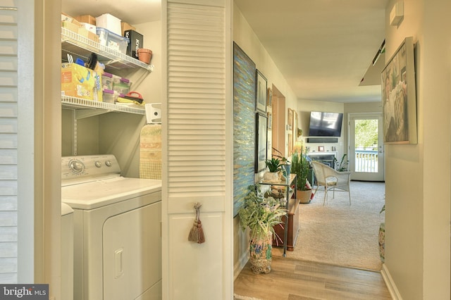 washroom with light hardwood / wood-style flooring and independent washer and dryer