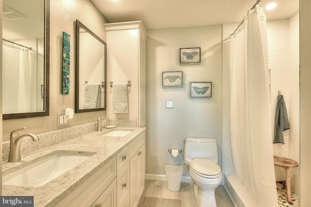 bathroom featuring wood-type flooring, toilet, vanity, and a shower with shower curtain