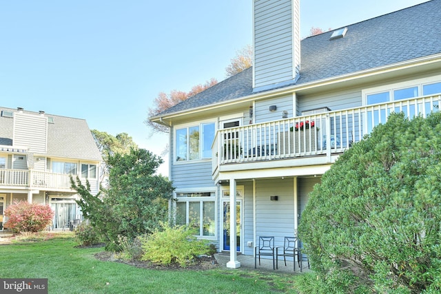 rear view of house with a lawn