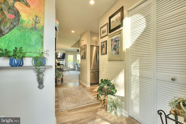 corridor with light hardwood / wood-style flooring