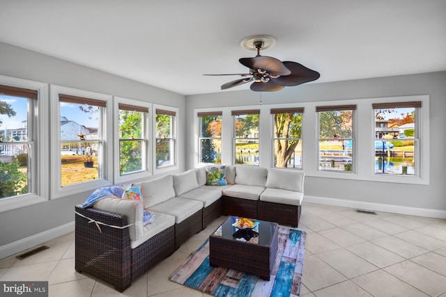 sunroom featuring ceiling fan