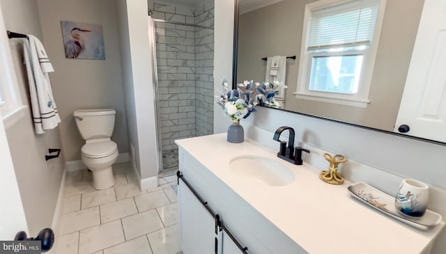 bathroom featuring vanity, toilet, and a tile shower