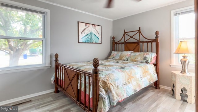 bedroom with crown molding, ceiling fan, and light wood-type flooring