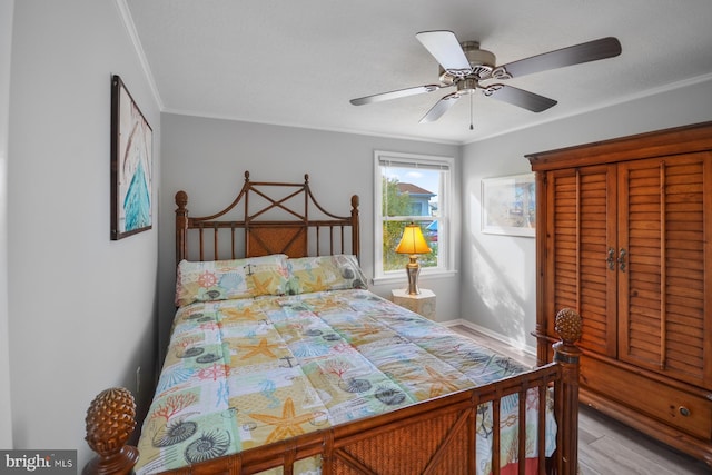 bedroom featuring crown molding, ceiling fan, and light hardwood / wood-style flooring