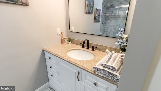 bathroom featuring vanity and a shower with door