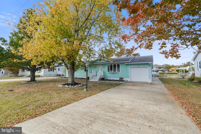 view of front of property with a garage and a front yard