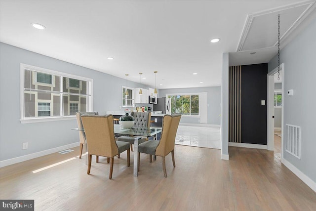 dining space featuring light wood-type flooring