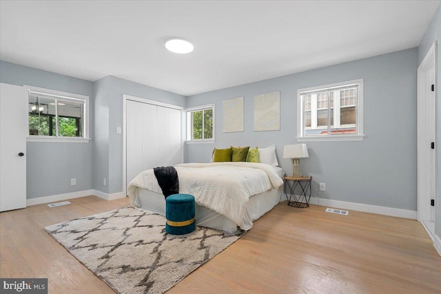 bedroom with a closet and light hardwood / wood-style flooring