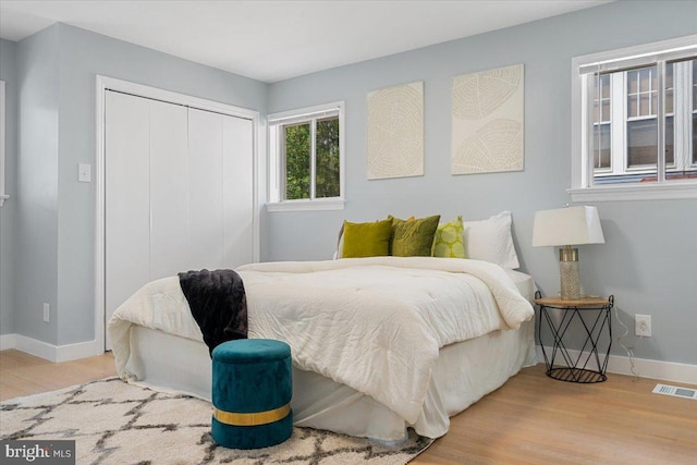 bedroom with a closet and light hardwood / wood-style flooring