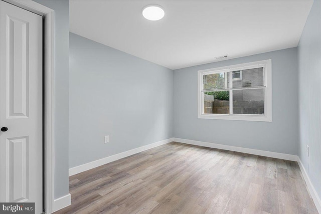 unfurnished room with light hardwood / wood-style flooring