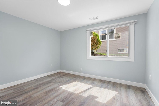 empty room with light hardwood / wood-style flooring