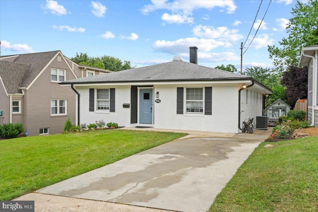 view of front of property with a front yard and cooling unit