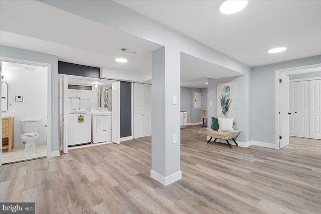 interior space with washer and dryer and light hardwood / wood-style floors