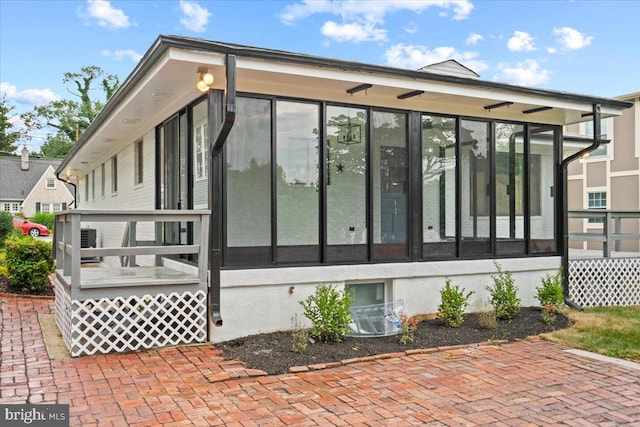 view of side of property with a sunroom