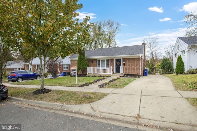 view of front of home with covered porch and a front yard