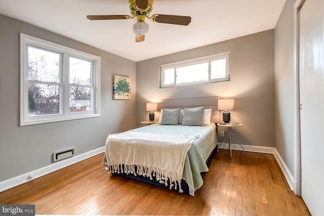 bedroom with ceiling fan and light hardwood / wood-style floors