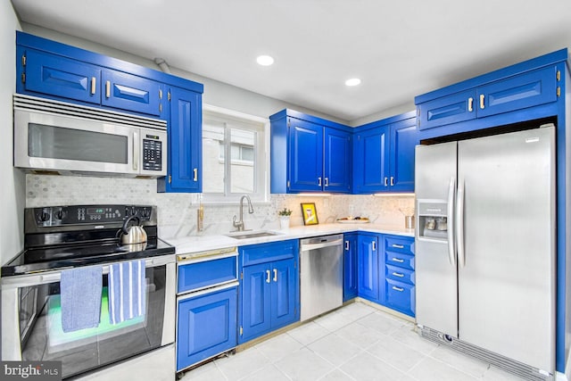 kitchen with blue cabinetry, sink, and appliances with stainless steel finishes