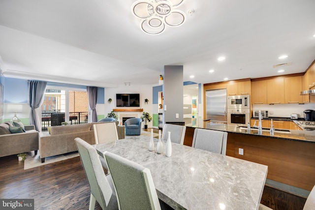 dining area featuring dark hardwood / wood-style flooring and sink