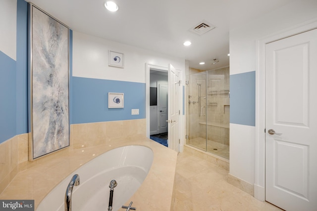 bathroom featuring shower with separate bathtub