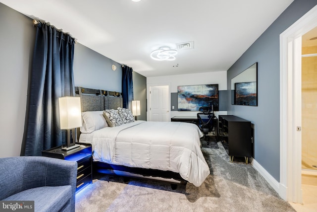 bedroom with carpet floors and ensuite bath