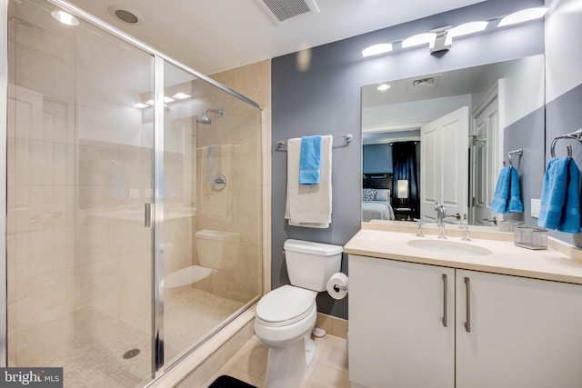 bathroom featuring toilet, vanity, tile patterned flooring, and a shower with door