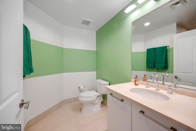 bathroom featuring toilet, tile patterned floors, and vanity