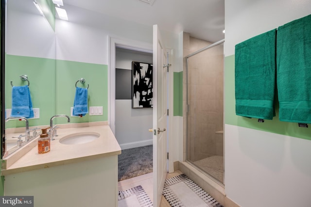 bathroom featuring tile patterned flooring, walk in shower, and vanity