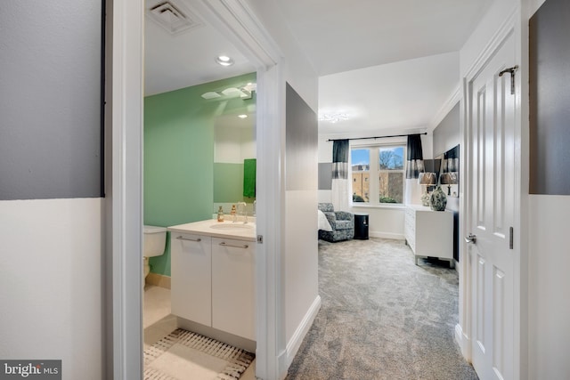 bathroom featuring toilet, vanity, and crown molding