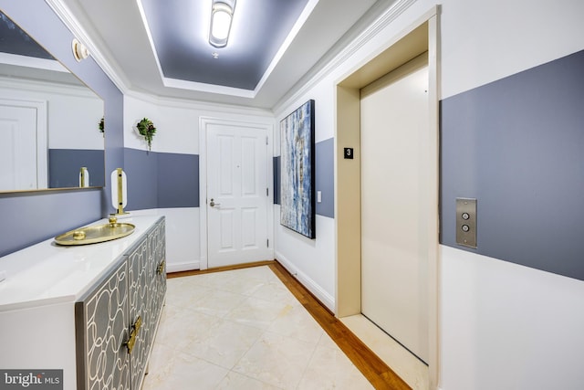 interior space featuring a tray ceiling and elevator