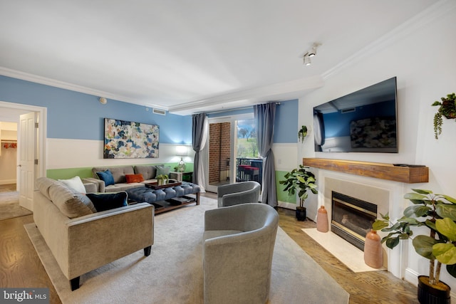 living room featuring crown molding and light hardwood / wood-style flooring